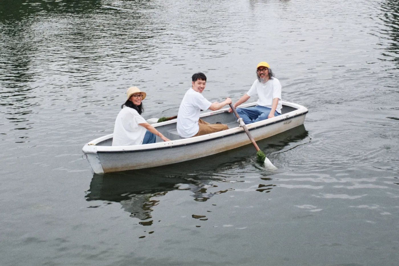 The three members rowing a boat